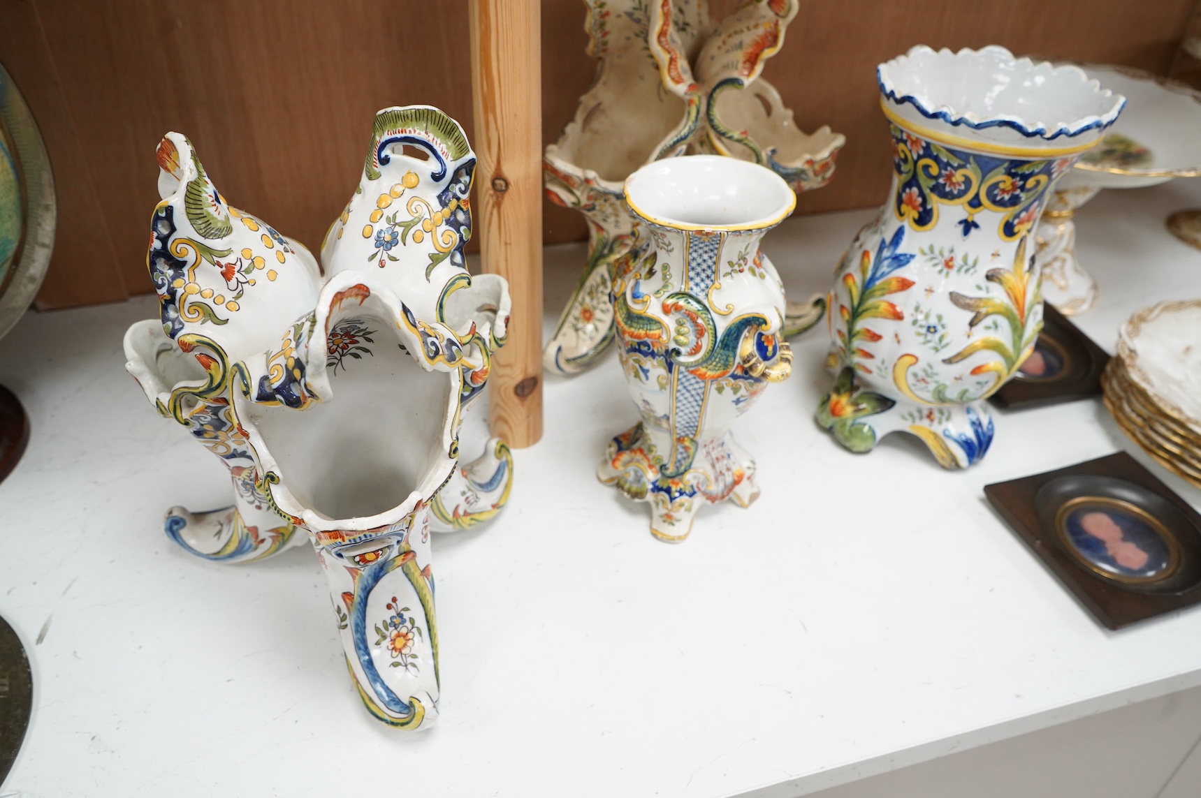 Two late 19th / early 29th century French faience vases and two similar centrepieces, largest 35cm high